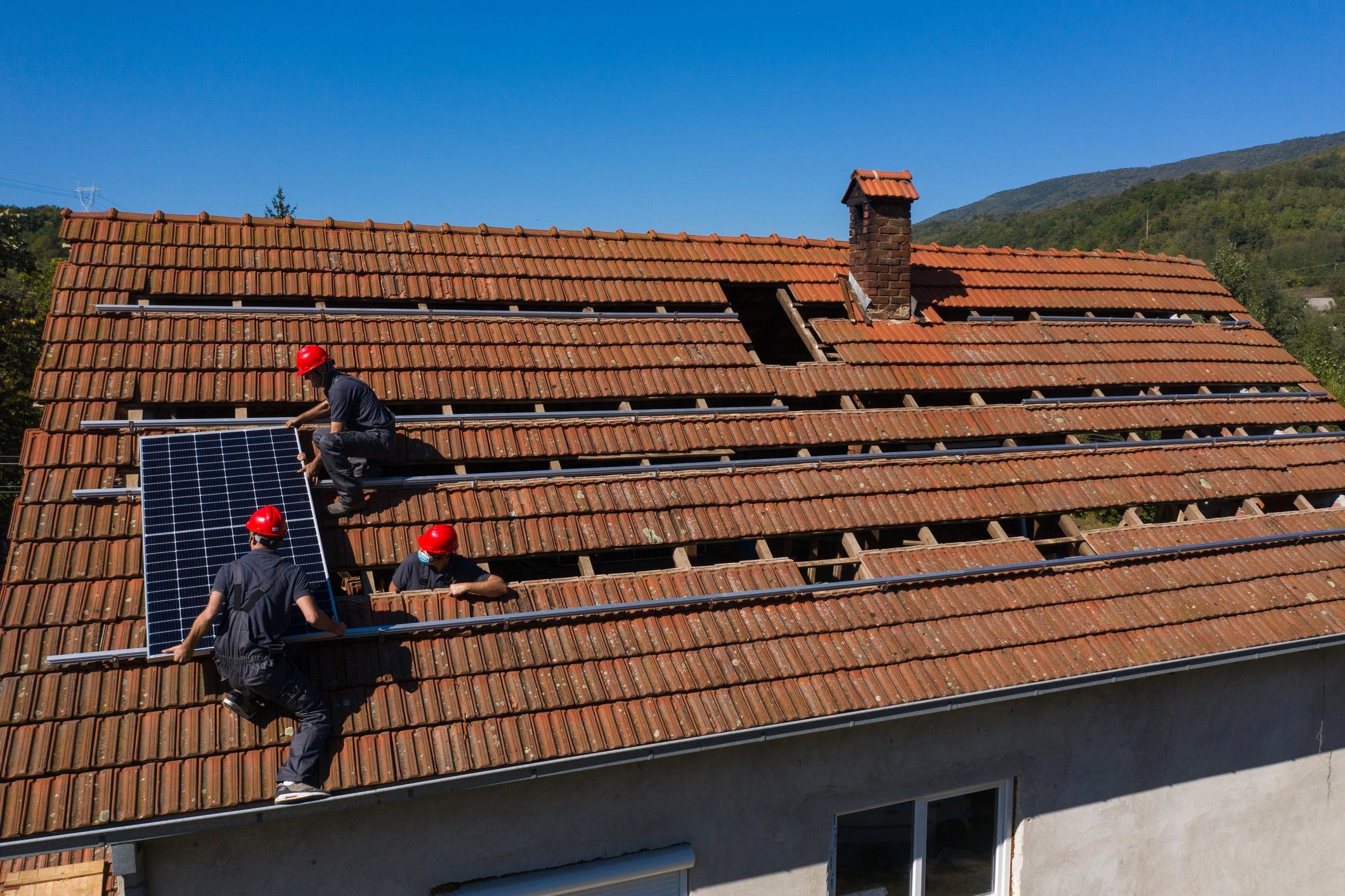 Roofing crew working together on a residential roof