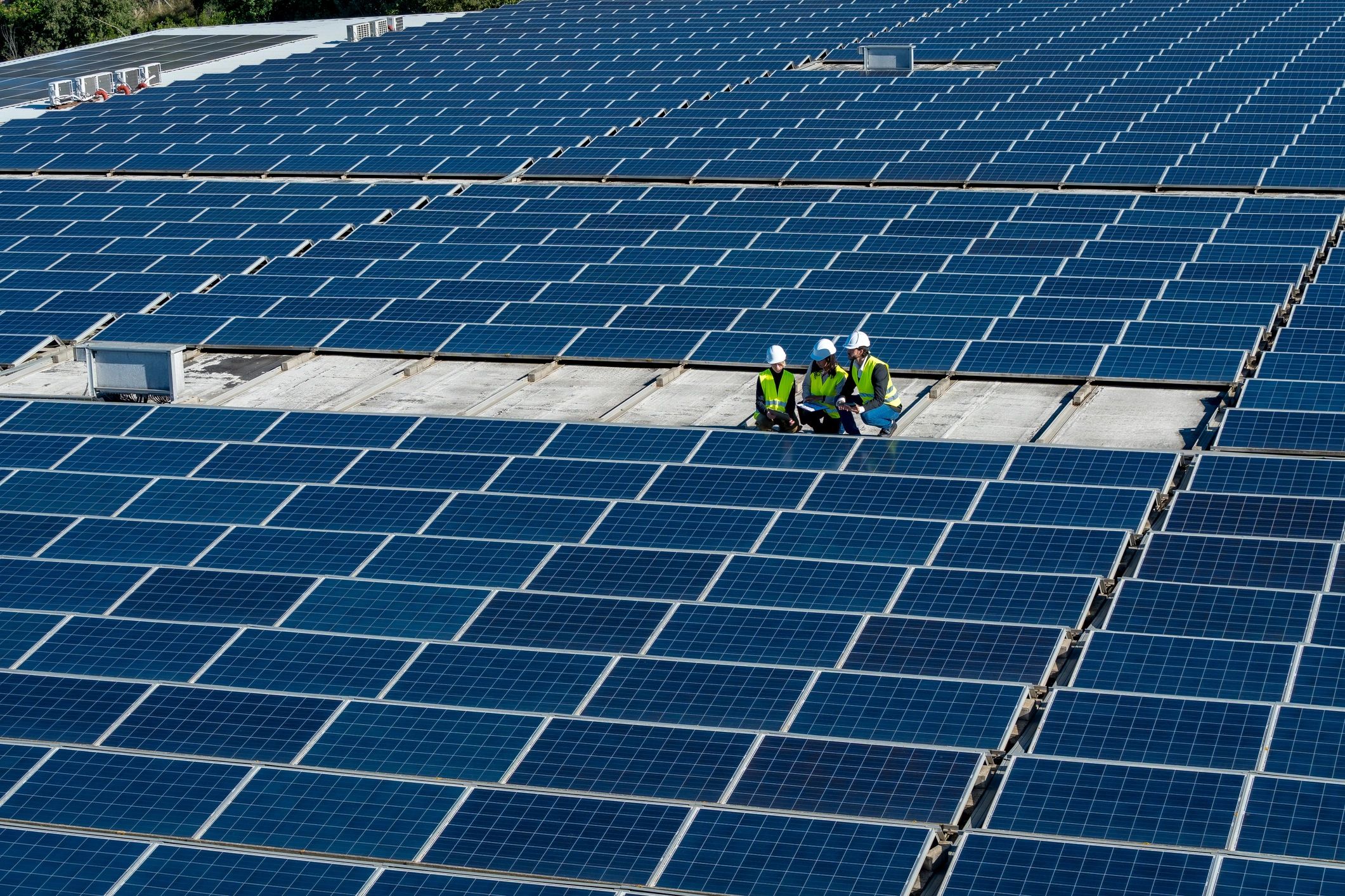 Commercial roofing professionals reviewing work on a rooftop