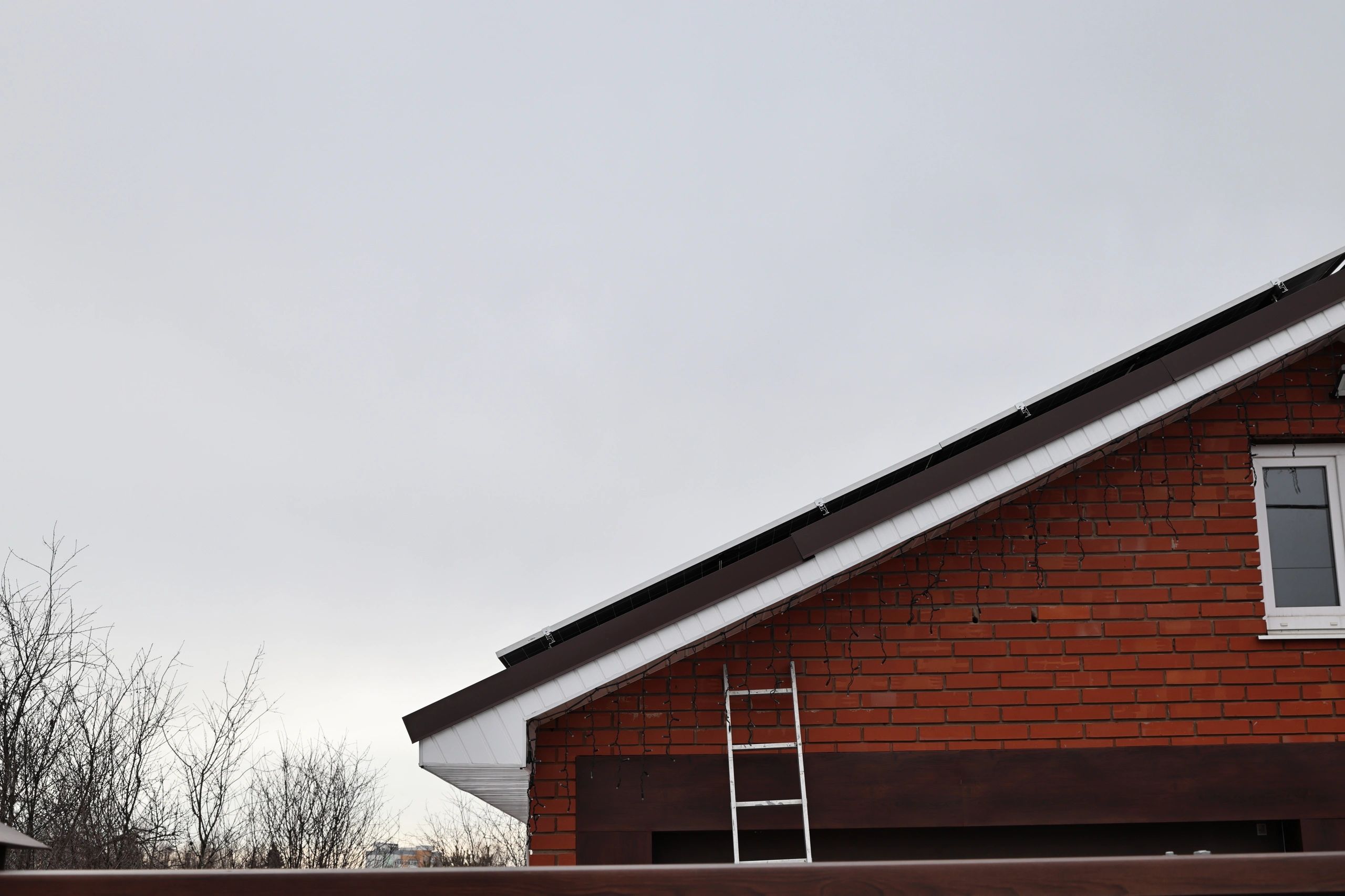 Residential roof project with ladder and roofing access
